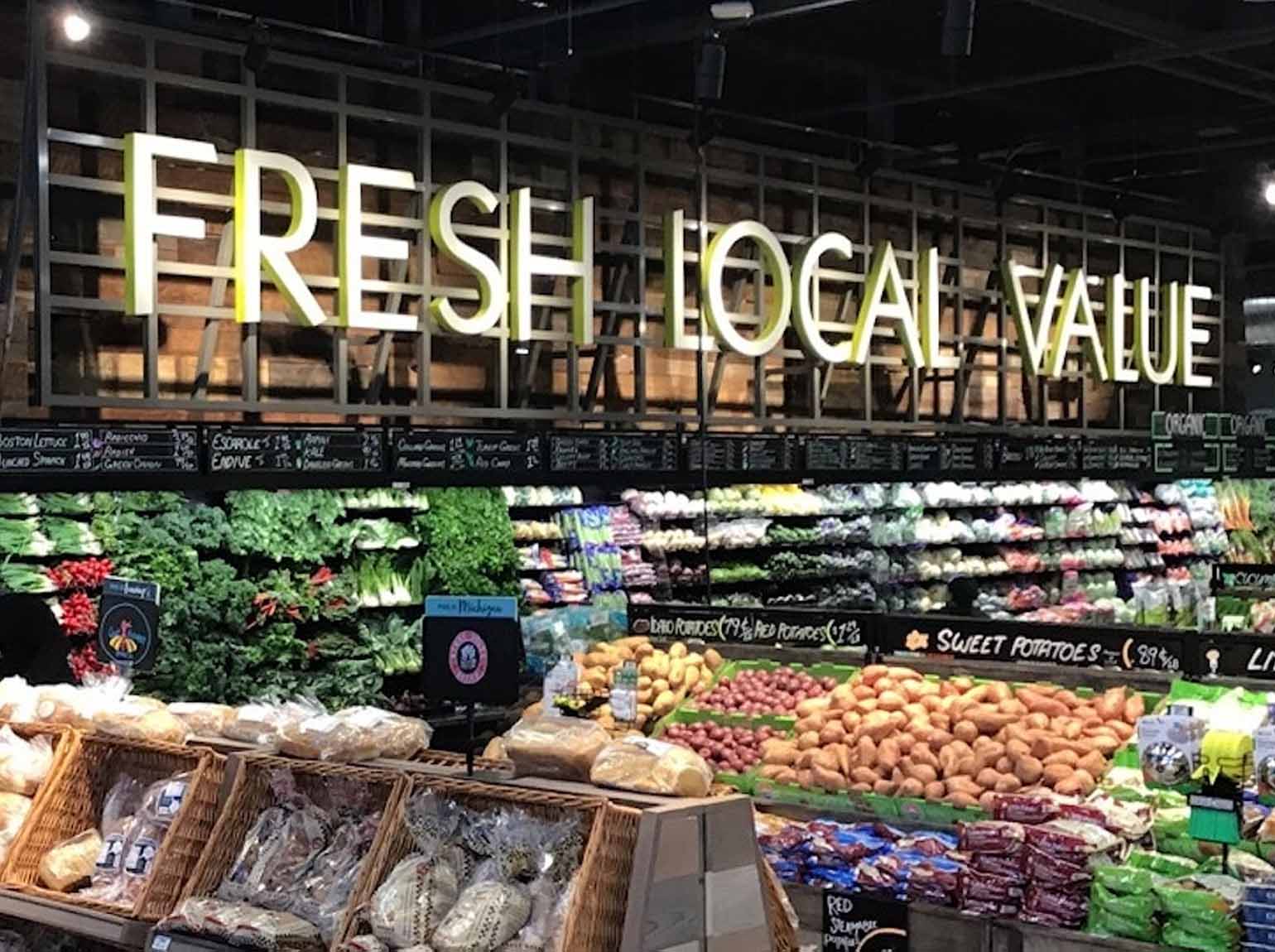 Meijer store interior with FRESH LOCAL VALUE produce department signage